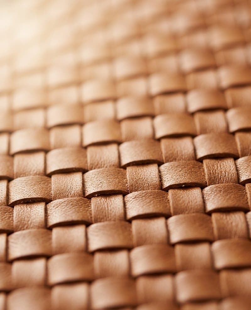 Close-up of the diagonal intrecciato; antique-brass hardware on the Vita
