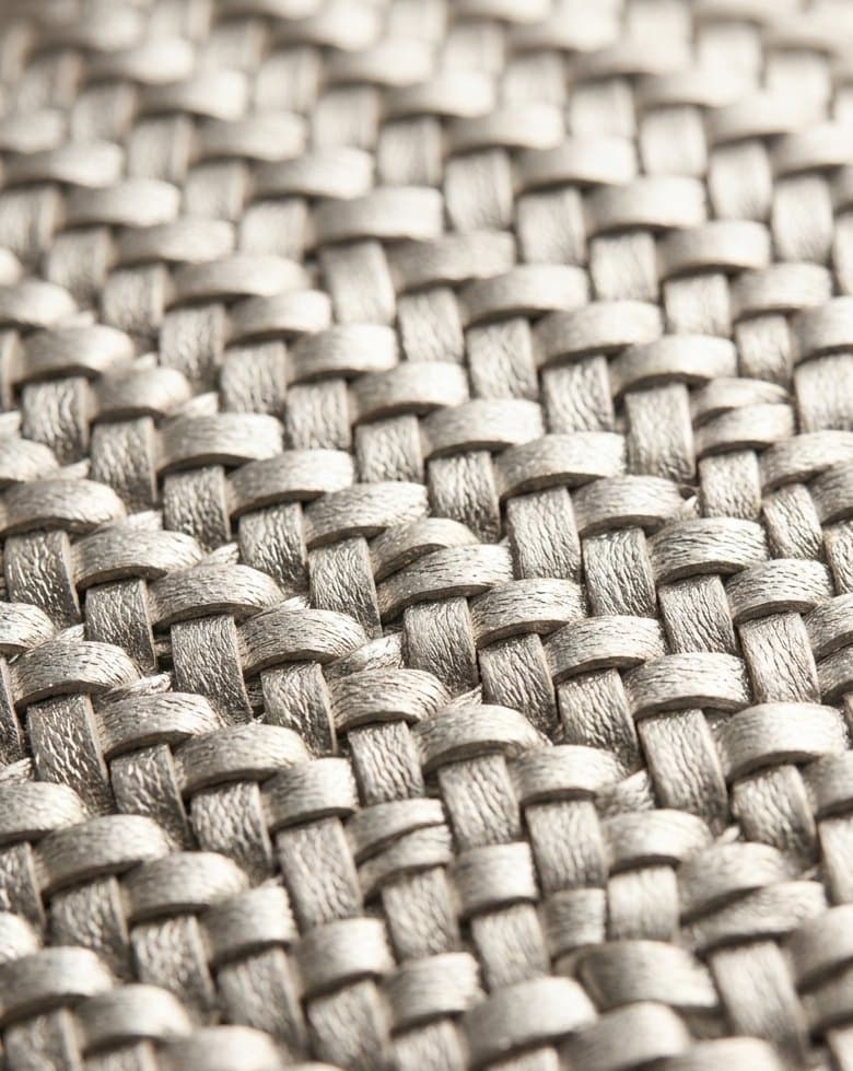 Close-up of the micro-weave metallic intrecciato; front flap closure on the Stella